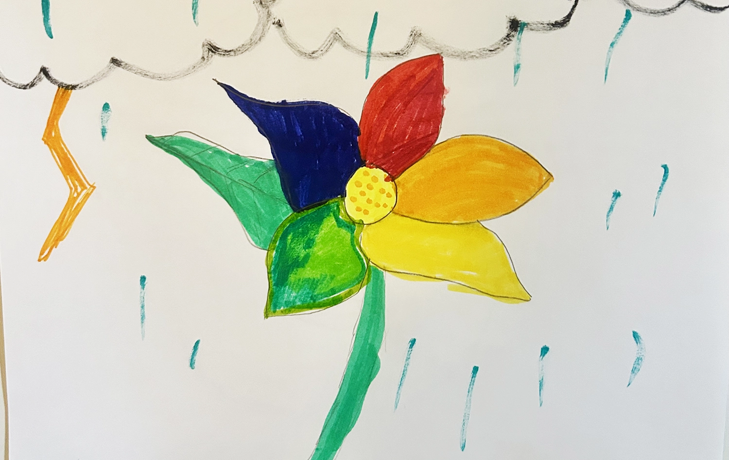 A colorful drawing of a flower created by an actual client's child.