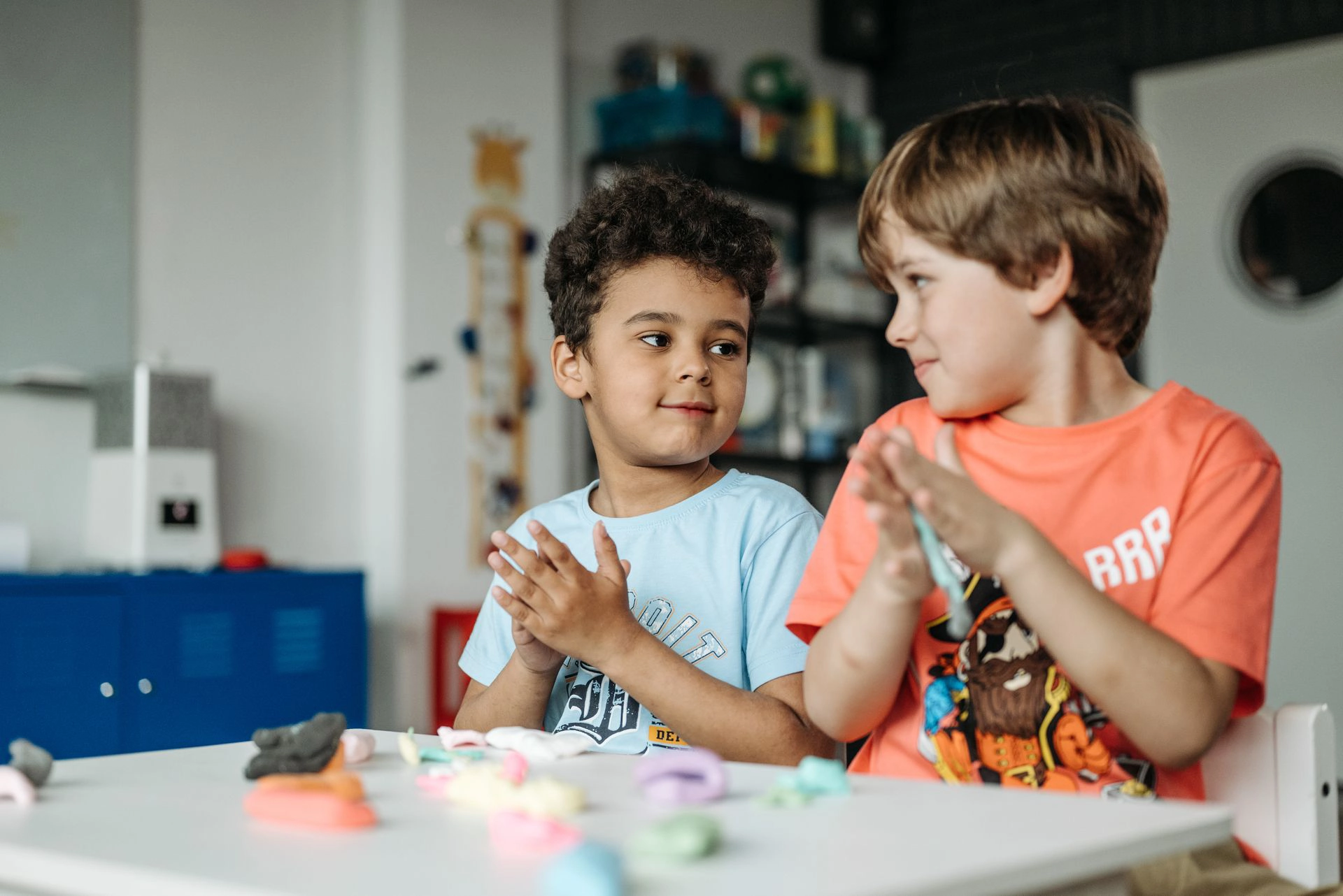 Two boys use clay to engage in Play-directed Therapy.