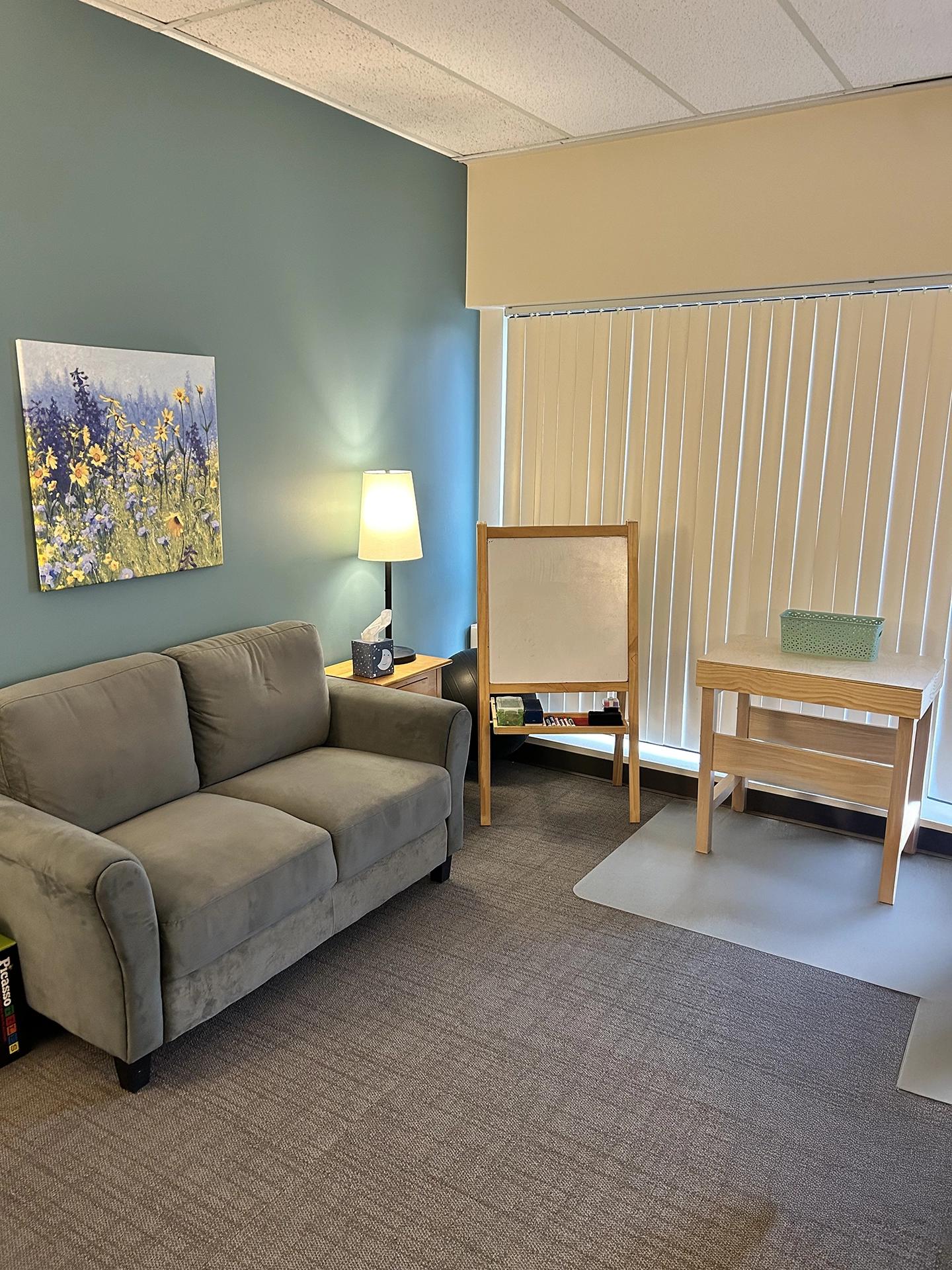 Comfortable counseling office with seating and creative therapy materials